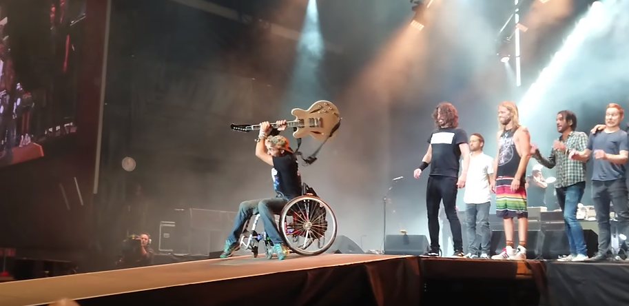 Watch the Foo Fighters invite fan in wheelchair on stage to smash Dave's guitar
