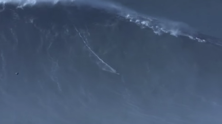 Brazil's Rodrigo Koxa surfs the biggest wave on record