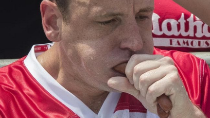 Hot dog eating champion breaks world record, downing 74 hotdogs in 10 minutes