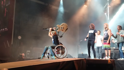 Watch the Foo Fighters invite fan in wheelchair on stage to smash Dave's guitar