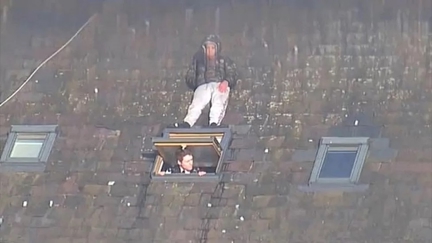 Man hides on roof from UK police